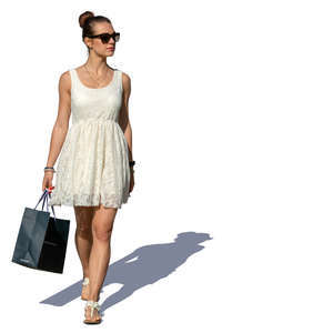 woman in a white summer dress with a shopping bag walking