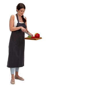 woman standing in a kitchen and slicing lettuce