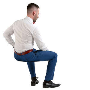 man in a suit and bow tie sitting
