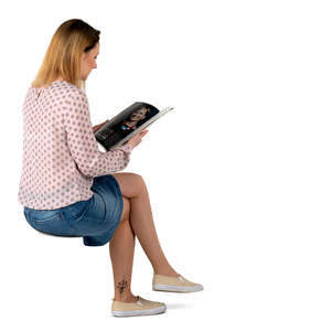 woman sitting and reading a magazine