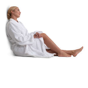 woman in a white bathrobe sitting
