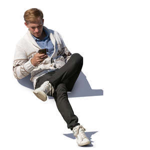 man sitting and checking his phone