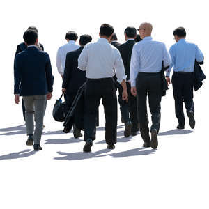 backlit group of businessmen walking