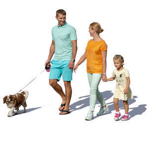 family with a dog walking hand in hand