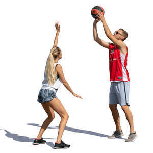 man and woman playing basketball outside