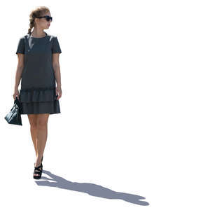 backlit woman with braided hair walking
