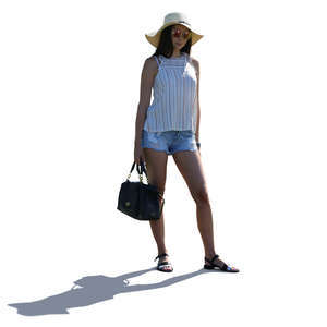 backlit woman with a hat standing