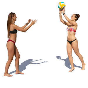 two women in bikinis playing beach volley