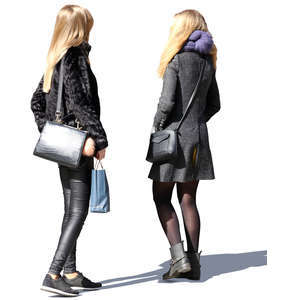 two blond women standing together in springtime