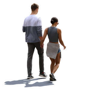 backlit couple walking hand in hand