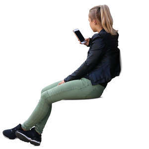 young woman sitting and looking at her phone