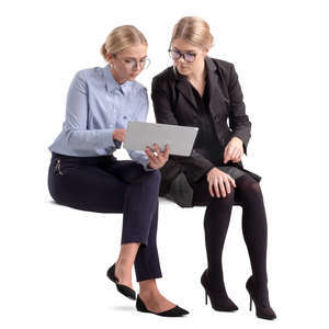 two businesswomen sitting and looking at some papers