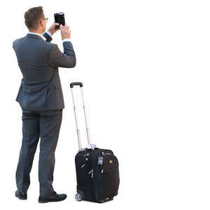 businessman with a suitcase standing and taking a picture