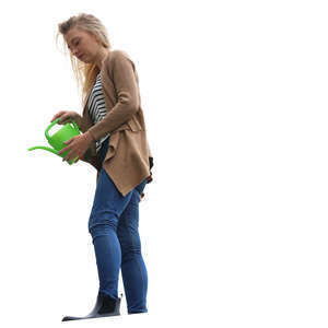 woman standing on a balcony and watering plants