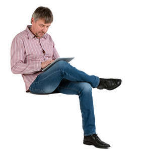 man sitting and working with tablet