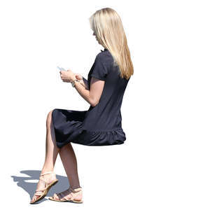 woman in a black summer dress sitting