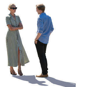 backlit man and woman standing and talking