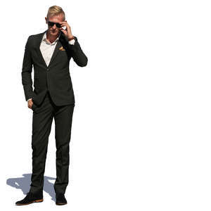 man in a suit standing in sunlight 