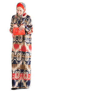 muslim woman standing and taking smth from her purse