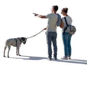 backlit couple with a dog