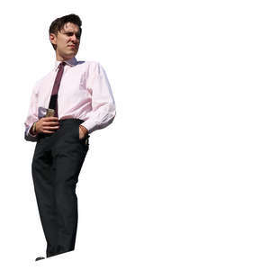 young man in a suit standing on a baclony