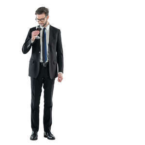 man in a suit drinking wine
