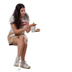 woman eating a bun in a cafe