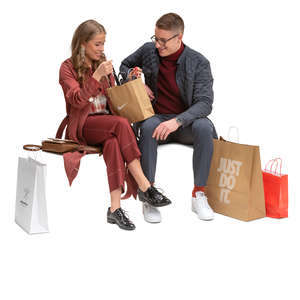 man and woman with shopping bags sitting