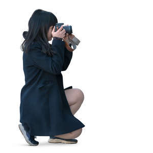asian woman squatting and taking a picture