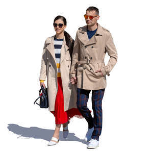 couple walking hand in hand on a sunny autumn day