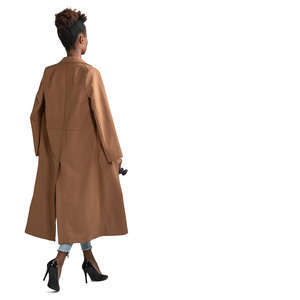black woman in a brown overcoat walking