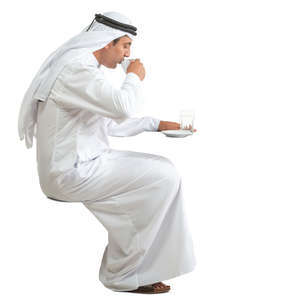 arab man sitting and drinking coffee