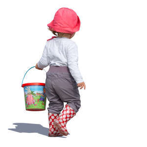 little girl with a toy bucket walking