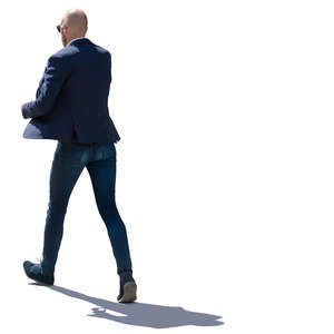 backlit man walking hastily