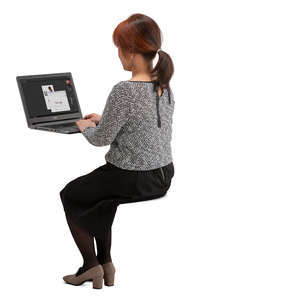 asian woman sitting behind an office desk