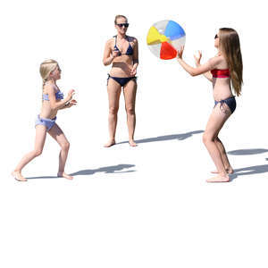 mother with two daughters playing ball at the beach