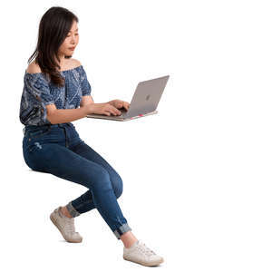 young asian woman sitting behind a desk