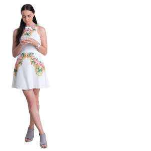 woman in a white mini dress standing