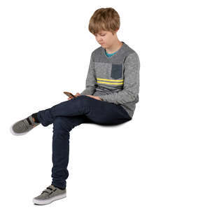 boy sitting and looking at his phone