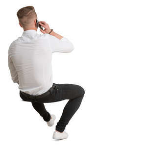 young man sitting and talking on a phone