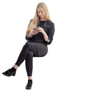 woman in black sitting and looking at her phone