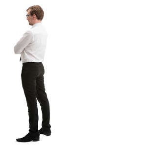 man in a suit standing an looking out of the window