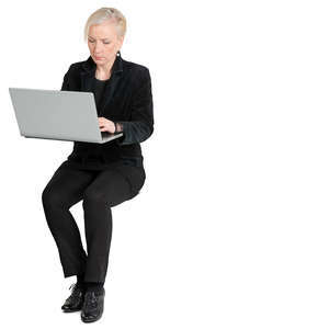 woman sitting and working on a laptop