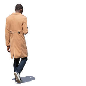 black man in a beige coat walking