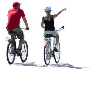 backlit man and woman biking