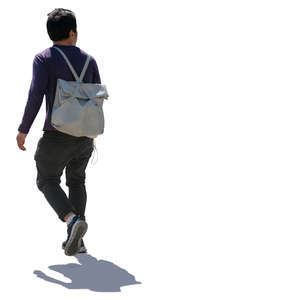 backlit asian man walking