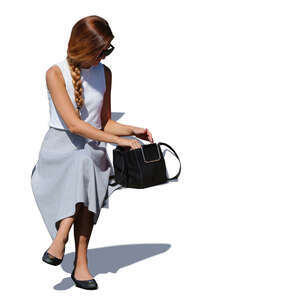 woman sitting and taking smth from her bag