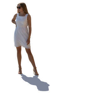 backlit woman in a white dress standing