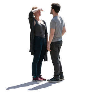 backlit man and woman standing and talking