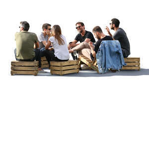 six people sitting in a park cafe and talking